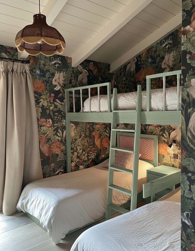 Grünes Etagenbett für drei Kinder in einem Kinderzimmer mit Waldtapete und schräger Decke