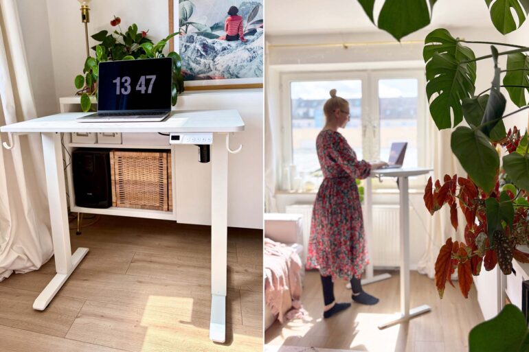Person arbeitet im Stehen am kleinen höhenverstellbaren Schreibtisch am Fenster im Wohnzimmer